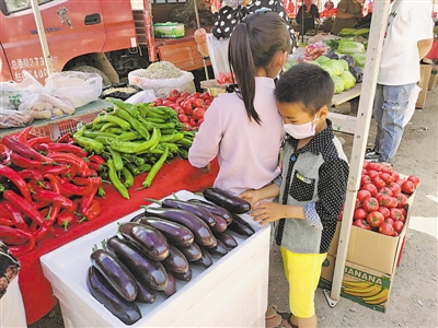 <p>　　一名小男孩在挑揀蔬菜。</p>